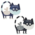 Two silver plated cat-shaped brooches with decorative elements on a white background