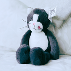 Klaus the Alex Clark plush cat with soft grey fur, white tummy, pink nose and embroidered smile