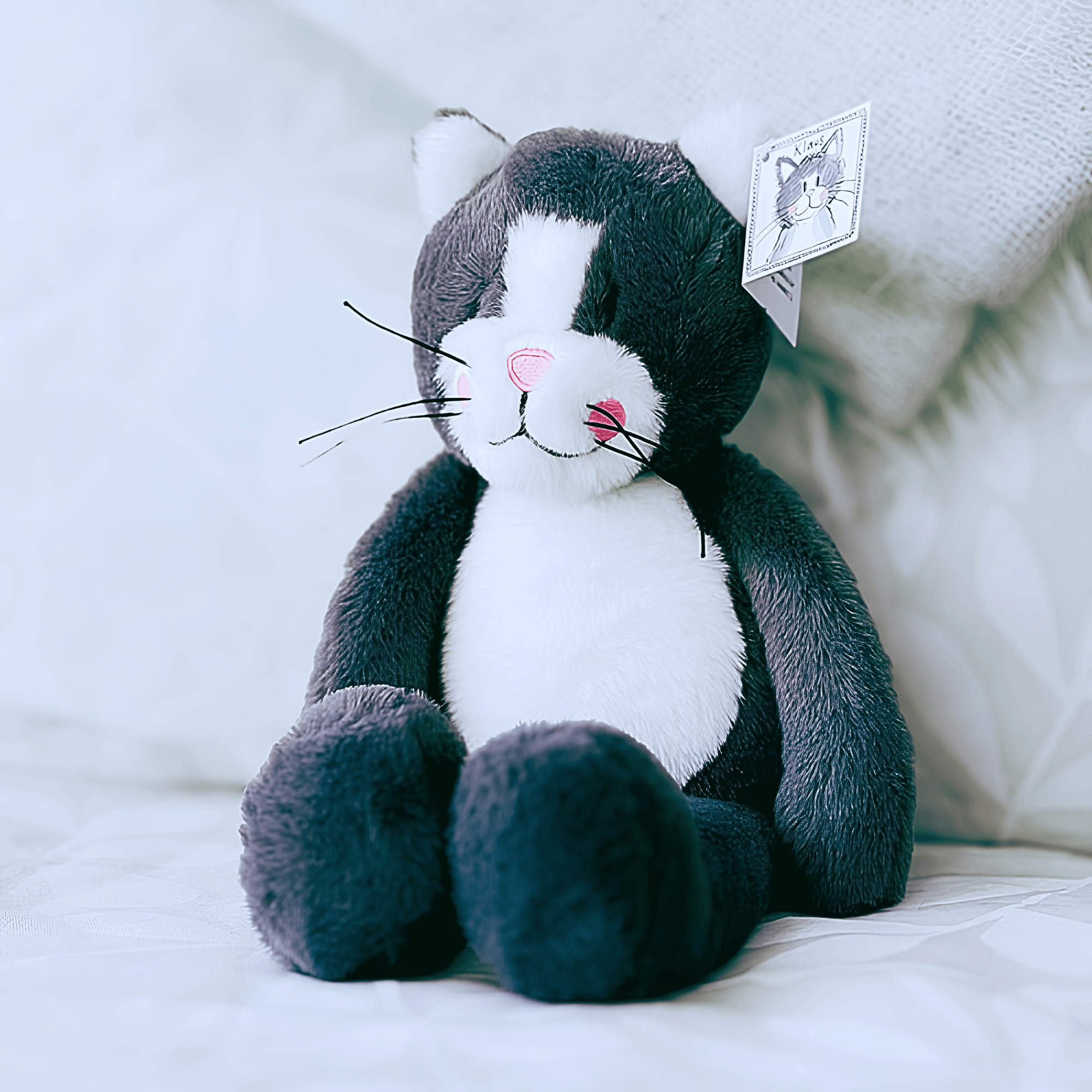 Klaus the Alex Clark plush cat with soft grey fur, white tummy, pink nose and embroidered smile