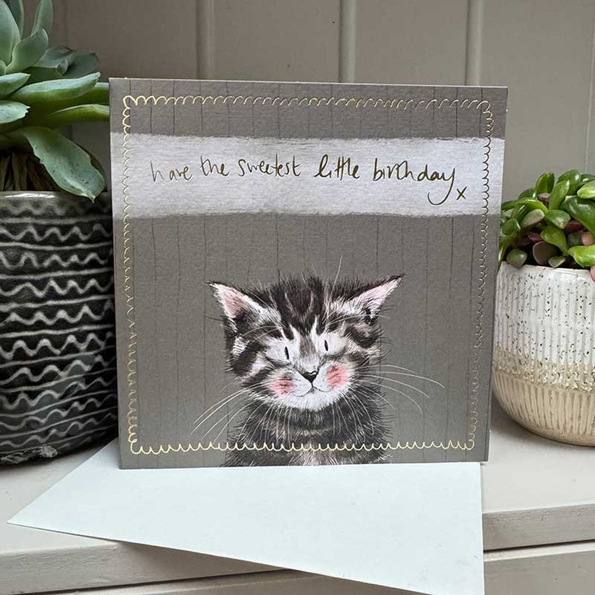 Alex Clark kitten birthday card displayed with its white envelope, featuring a tabby kitten illustration and delicate gold foil detailing.