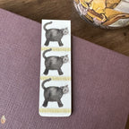 Alex Clark Little Treacle magnetic bookmark displayed on a closed journal, highlighting the compact magnetic design and playful cat artwork.