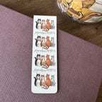 Alex Clark Marvellous Moggies magnetic bookmark displayed on a closed journal, highlighting the compact magnetic design and charming cat artwork.