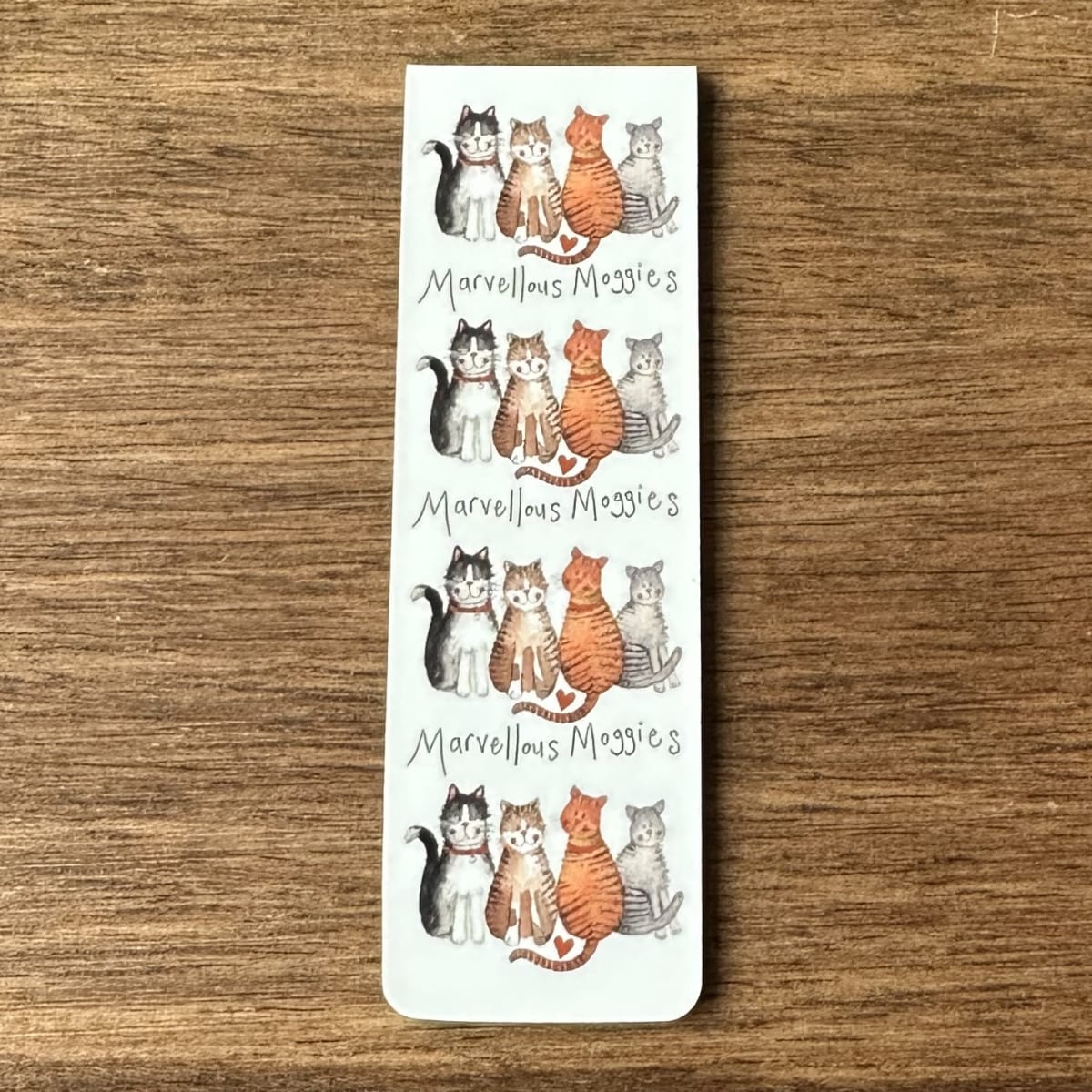 Alex Clark Marvellous Moggies magnetic bookmark shown folded to demonstrate the secure magnetic design for marking book pages.