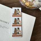 Alex Clark Tortoiseshells magnetic cat bookmark clipped onto the page of an open book, showing how the magnetic bookmark securely holds your place.