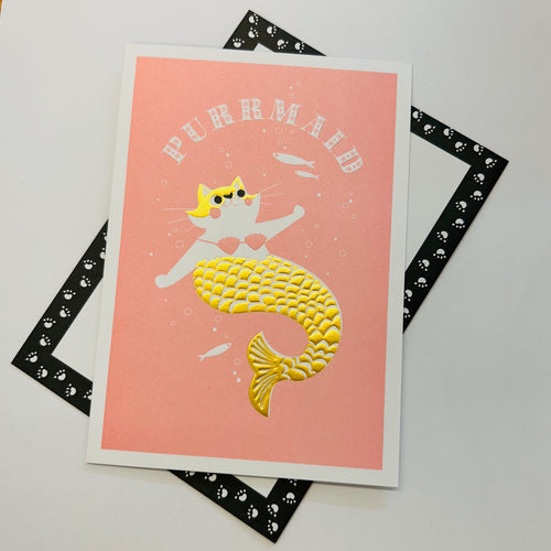 Art File Purrmaid any occasion cat greetings card featuring a cat mermaid with a gold-coloured tail, embossed details and a pink background.