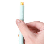 Hand twisting Beans & Co Twist Pop Cat Pen to reveal the hidden cat