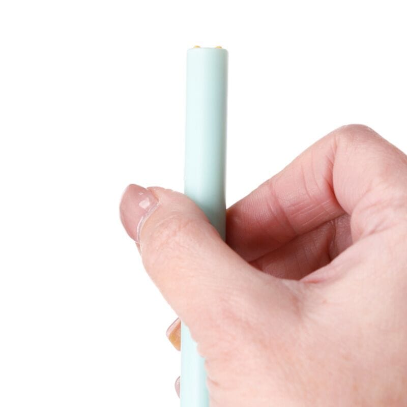 Hand twisting Beans & Co Twist Pop Cat Pen to reveal the hidden cat
