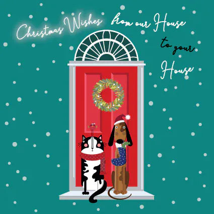 From Our House to Yours Christmas card with black and white cat and brown dog in festive scarves beside a snowy red front door with Christmas wreath