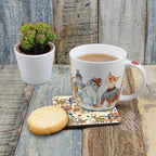 Emma Ball Kittens in Mittens bone china cat mug filled with tea beside a matching cat coaster