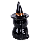 Side view of witchy black cat Halloween mug showing glossy black finish, pointed hat lid and curled cat-tail handle
