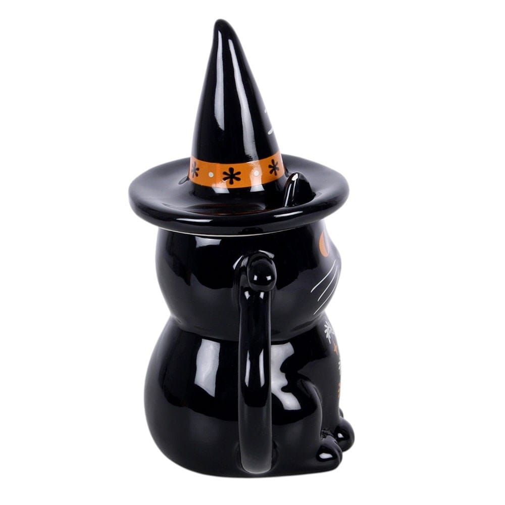 Side view of witchy black cat Halloween mug showing glossy black finish, pointed hat lid and curled cat-tail handle
