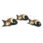 Set of three Fair Trade handmade wooden sleeping cat ornaments in brown, black and cream, with curled-up bodies and delicate whiskers.