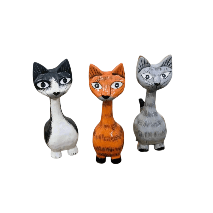 Three Fair Trade handmade medium wooden cat ornaments from Bali in black and white, ginger and grey, with expressive faces and long necks.