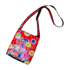 Fair Trade handmade red leather shoulder bag featuring three colourful cats, bright floral patterns and an adjustable crossbody strap.