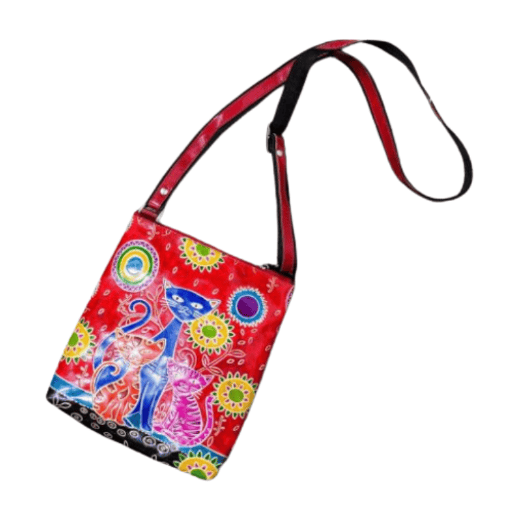 Fair Trade handmade red leather shoulder bag featuring three colourful cats, bright floral patterns and an adjustable crossbody strap.