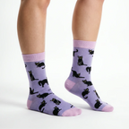 Front view of Socktopus Black Cats bamboo socks in lilac, highlighting the playful black cat design and pink contrast cuffs, heels and toes.