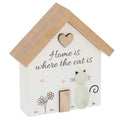 Decorative house-shaped sign with a raised pebble cat, illustrated flowers and beautiful text 'Home is where the cat is' on a white background.