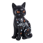 Frightful Folk black cat resin ornament with orange eyes, white botanical branches, stars and spooky folk-inspired painted details