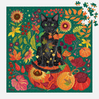 Galison Whiskers of Autumn 500 piece black cat jigsaw puzzle nearly completed with loose pieces showing a richly coloured autumn floral design.
