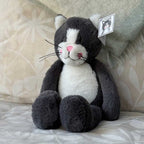 Stuffed toy cat relaxing on a soft chair