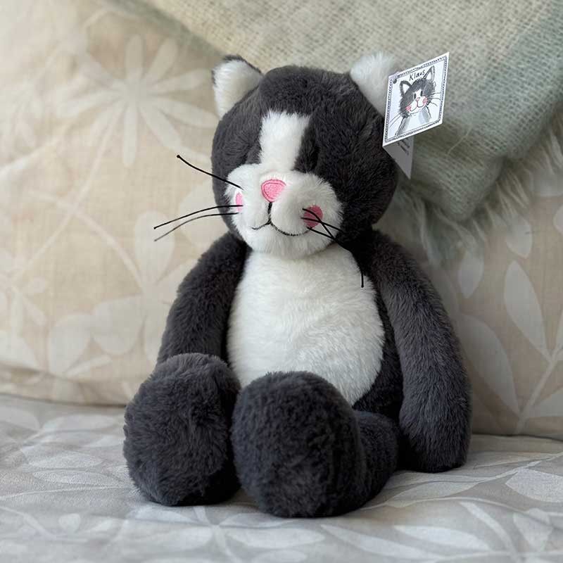 Stuffed toy cat relaxing on a soft chair