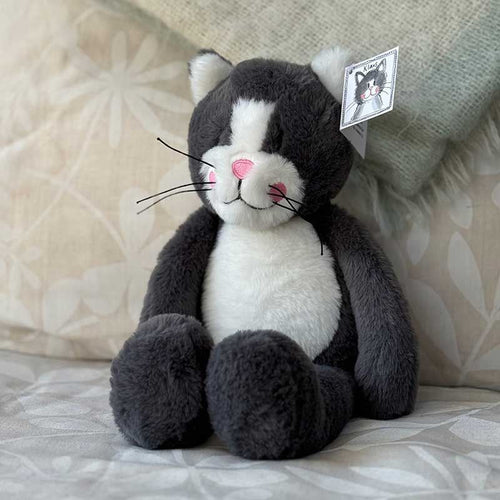 Stuffed toy cat relaxing on a soft chair