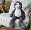 Plush toy cat sitting on a cushioned chair