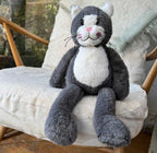 Plush toy cat sitting on a cushioned chair