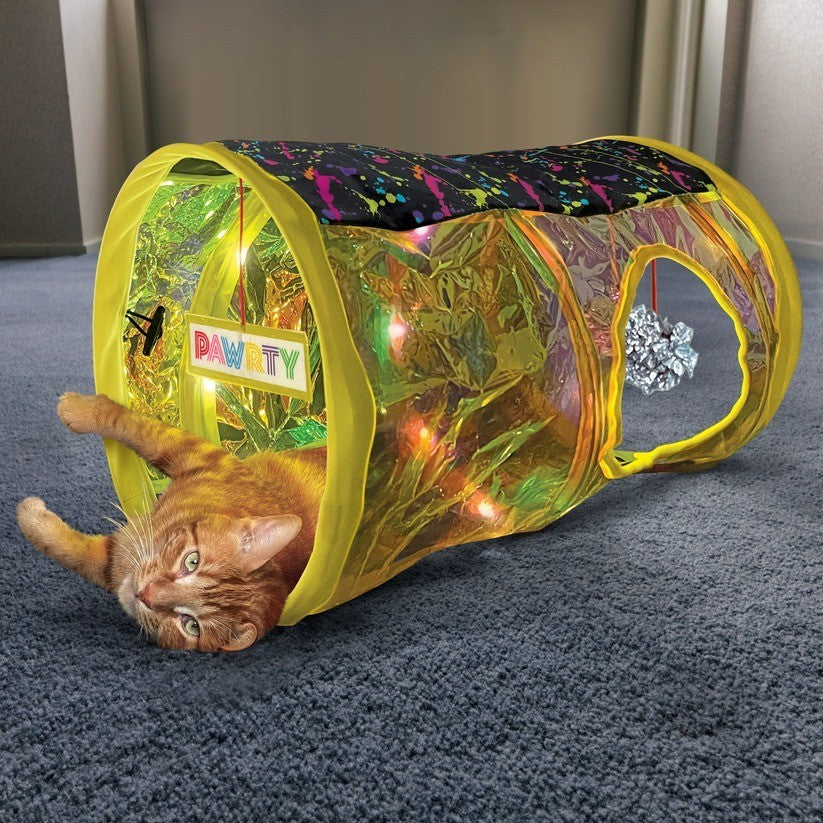 Ginger cat relaxing inside the KONG Rave Cave Disco Tunnel with colourful lights glowing during play