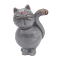 Ceramic cat-shaped figurine with a face on a white background