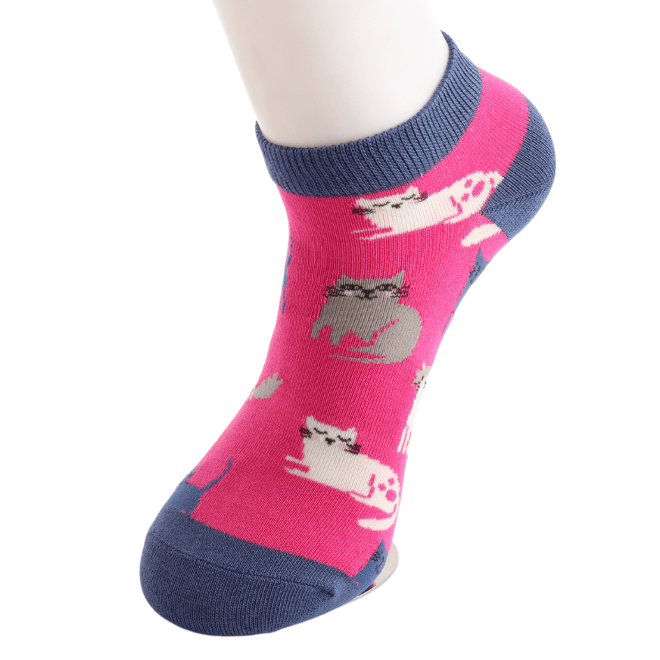 Miss Sparrow ladies' hot pink bamboo trainer sock worn on a mannequin foot, featuring playful white, grey and navy kittens with a low-cut trainer sock design.