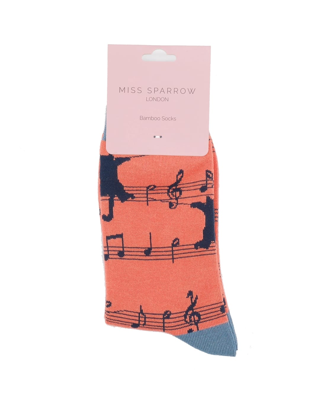 Miss Sparrow Ladies Bamboo Socks in vibrant orange with playful black cat silhouettes and musical notes, displayed in branded gift packaging with contrasting blue-grey toe.