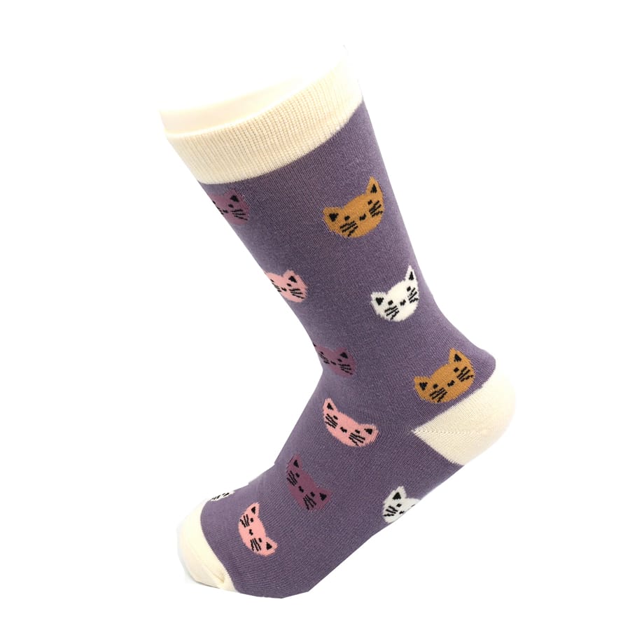 Miss Sparrow Ladies Bamboo Cat Socks 'Kitty Faces' in lavender, displayed on a mannequin foot, featuring colourful smiling cat faces with cream heel, toe and cuff.