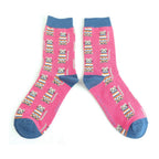 Pair of Miss Sparrow 'Cosy Kitties' bamboo socks in hot pink, showcasing colourful striped cats across a bright pink background with contrasting denim blue heels, toes and cuffs.
