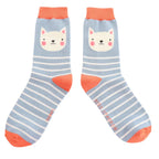 Front view of Miss Sparrow 'Kitty Stripes' bamboo socks in powder blue, highlighting the adorable white cat design, crisp white stripes and vibrant coral orange accents.