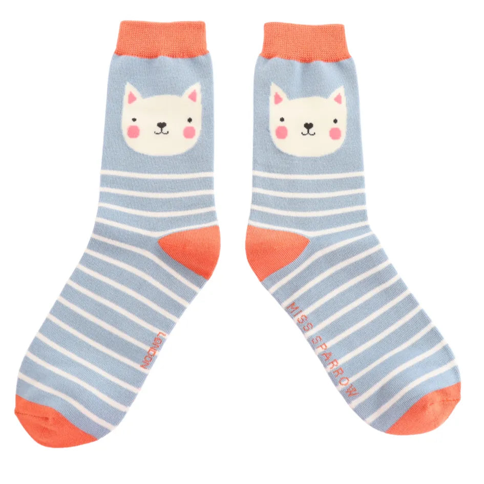 Front view of Miss Sparrow 'Kitty Stripes' bamboo socks in powder blue, highlighting the adorable white cat design, crisp white stripes and vibrant coral orange accents.