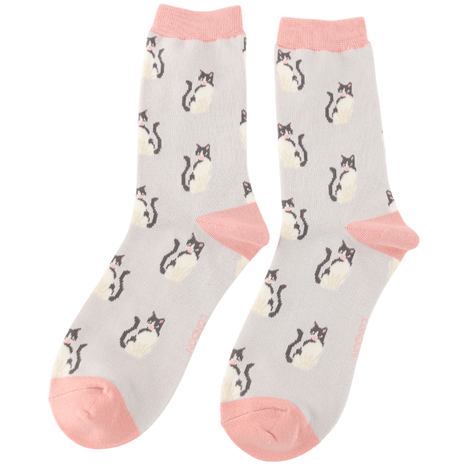 Pair of Miss Sparrow bamboo cat socks showing an all-over black and white cat pattern on a silver grey background with contrasting soft pink heels, toes and cuffs.