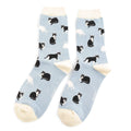 Pair of Miss Sparrow Ladies Bamboo Socks in powder blue featuring playful black and white cat silhouettes on a soft blue background with cream heels, toes and cuffs, made from a soft bamboo-rich fabric.