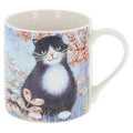 Penny Gaj Gorgeous black and white cat ceramic mug featuring a green-eyed tuxedo cat surrounded by delicate peach flowers against a soft blue background, gift boxed.