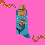 Socktopus Sparkly Cat Mermaid combed cotton socks in retail packaging, featuring a tabby cat mermaid with a shimmering glitter-effect blue tail on an aqua background.