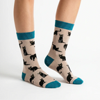 Side view of Ladies grey bamboo socks featuring playful black cats with teal heels, toes and cuffs by Socktopus.