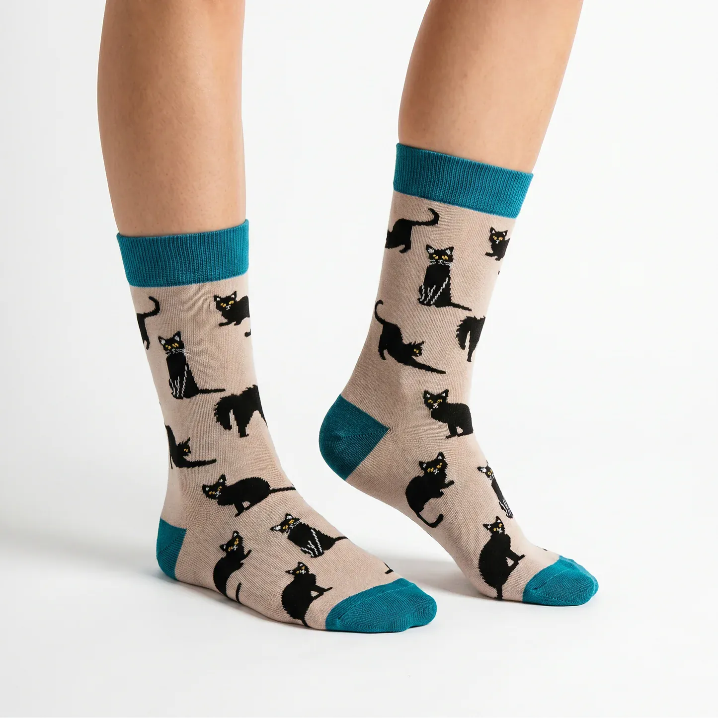 Side view of Ladies grey bamboo socks featuring playful black cats with teal heels, toes and cuffs by Socktopus.