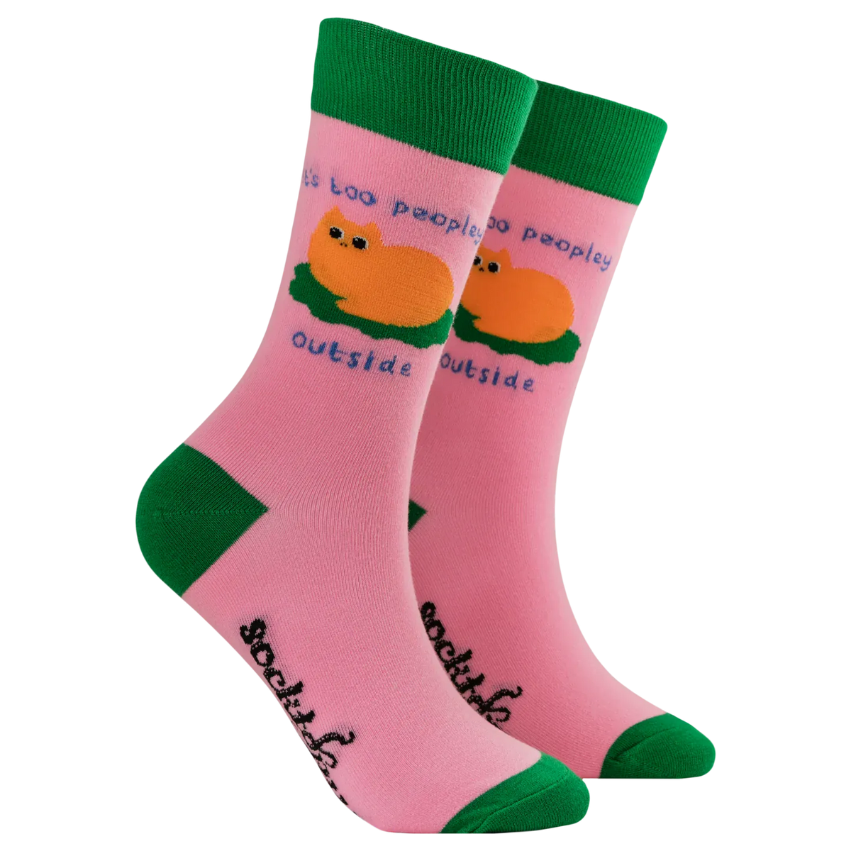 Pair of Socktopus Ladies It's Too Peopley Outside cat socks showing a ginger cat curled up on a green cushion, blue slogan lettering, pink fabric and contrasting green cuffs, heels and toes.