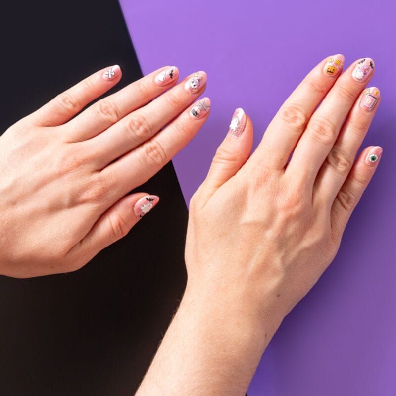 Halloween nail stickers applied to fingernails with spooky designs