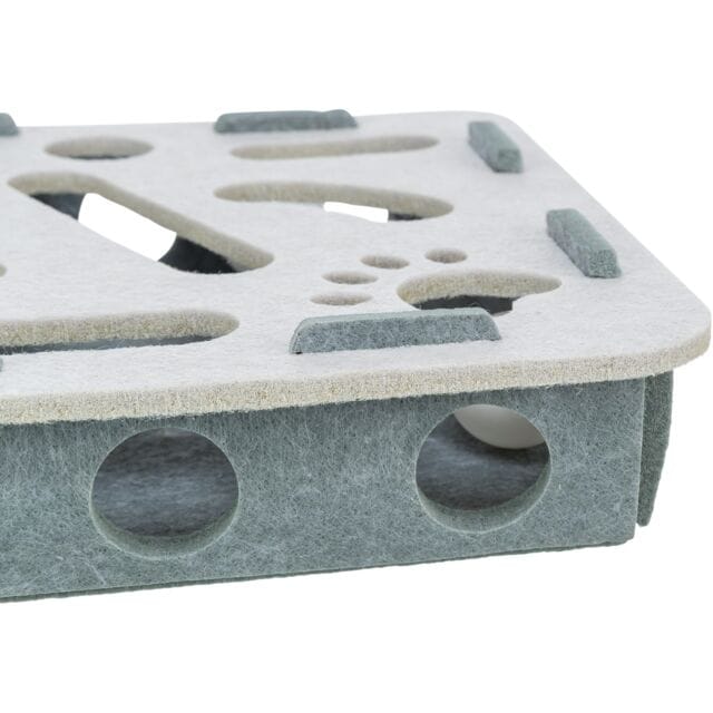 Angled view of Trixie Hole 'n' Roll felt puzzle toy showing hidden rolling balls and play openings

