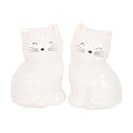 White ceramic cat salt and pepper shakers featuring two adorable smiling cats with pink ears, black whiskers and glossy finish, sitting side by side.