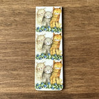 Alex Clark Three Amigos magnetic bookmark shown folded to demonstrate the secure magnetic design for marking book pages.
