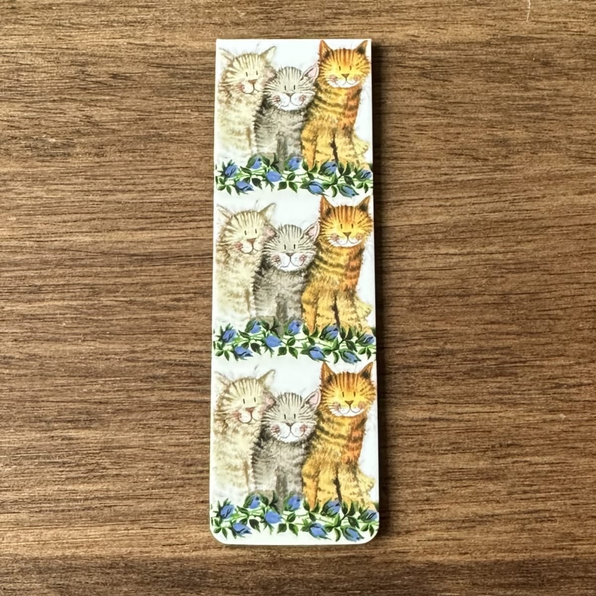 Alex Clark Three Amigos magnetic bookmark shown folded to demonstrate the secure magnetic design for marking book pages.
